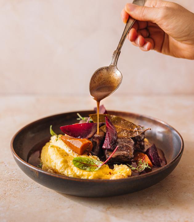 Venison dish in a brown plate, which was refined with Mozart Chocolate Liqueur.